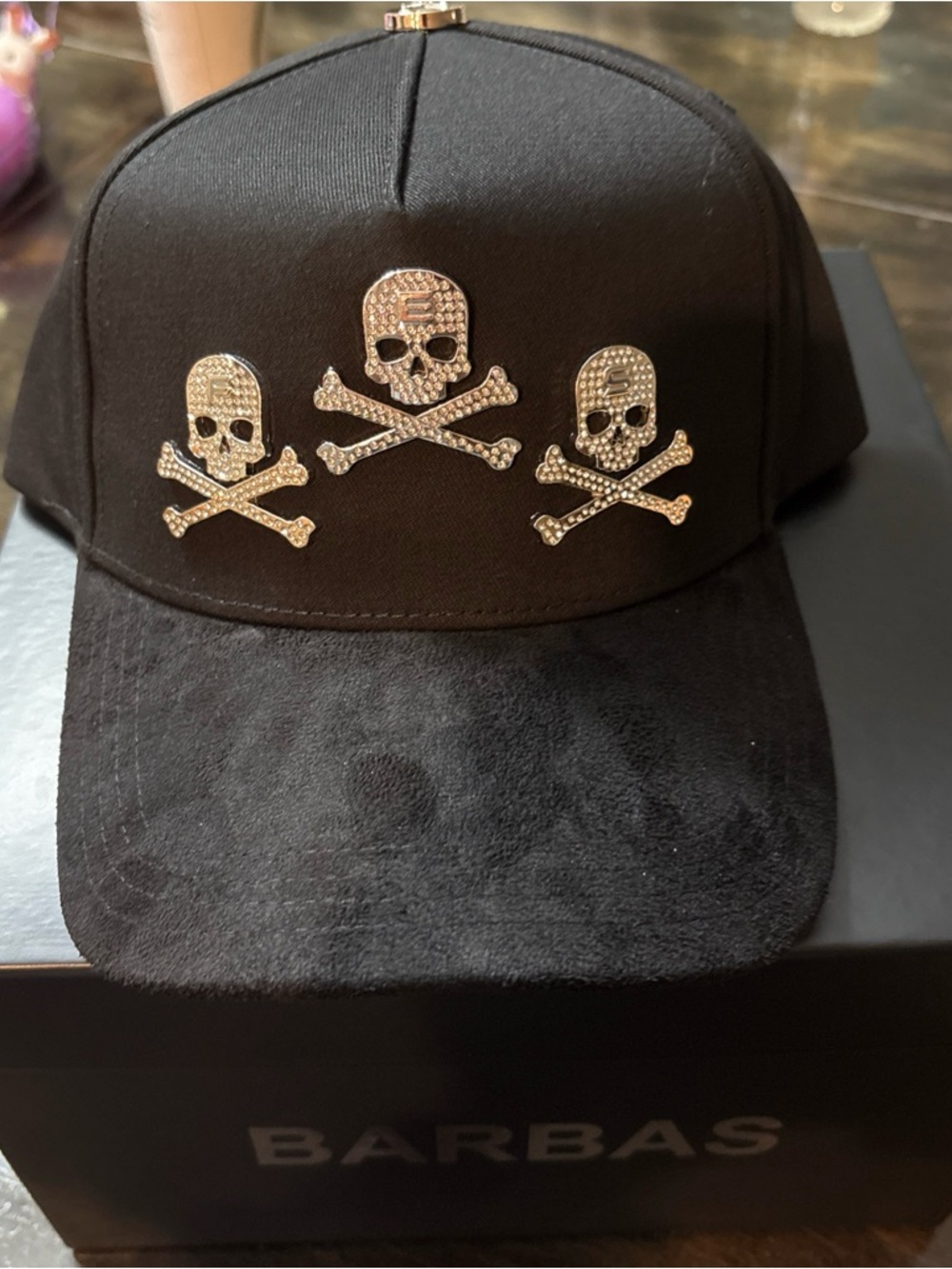 Black Cap with Gold Skull & Crossbones Accents